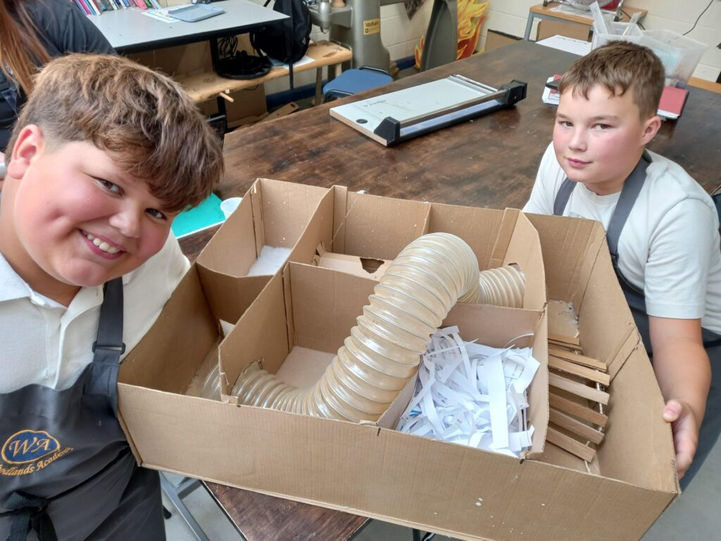pupils sit alongside their gerbil maze creation